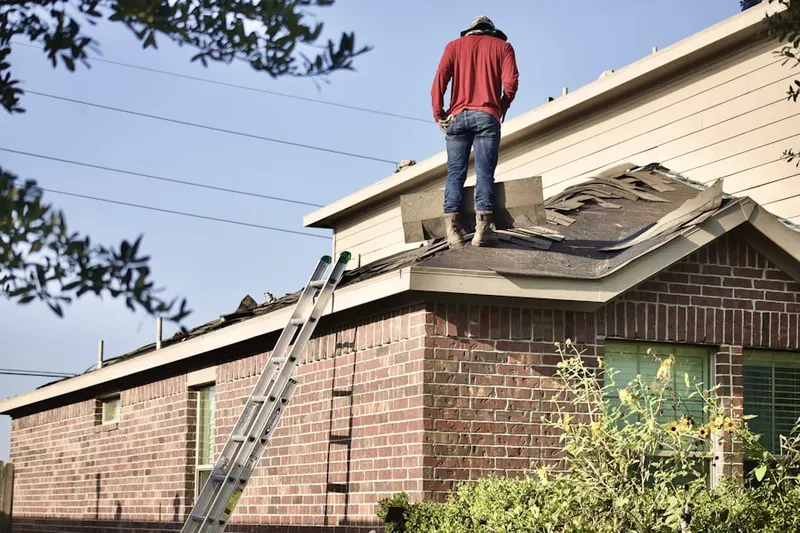 Professional roofer working on a residential roof in Palestine